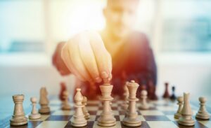 Sales leader playing chess, thinking about tactics to help his team dominate sales