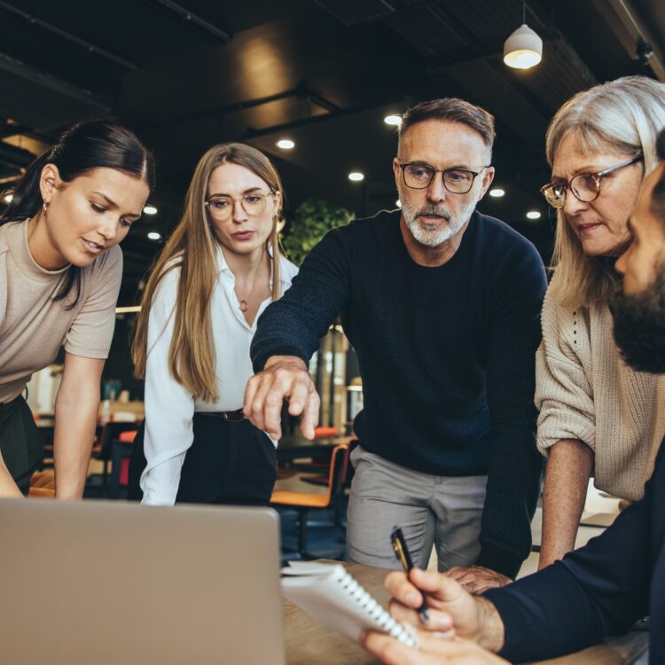 Focused,Businesspeople,Having,A,Discussion,While,Collaborating,On,A,New